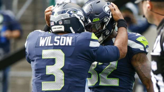 Sep 19, 2021; Seattle, Washington, USA; Seattle Seahawks running back Chris Carson (32) celebrates with quarterback Russell Wilson (3) after rushing for a touchdown against the Tennessee Titans during the second quarter at Lumen Field. Mandatory Credit: Joe Nicholson-USA TODAY Sports